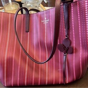 I am selling a Kate Spade burgundy bag with hearts for $60.